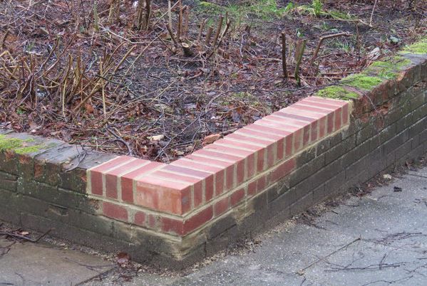 Landscaping retaining wall with brick repair