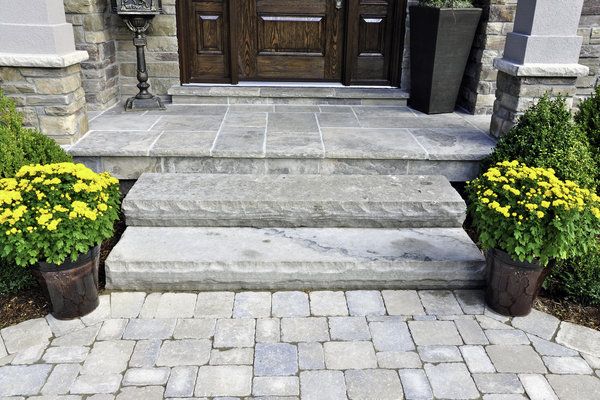 Stone paver home entrance way with stone steps